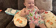 Arizona joined the competition — help win amazing prizes! baby, smiling, couch, pillow, infant, clothing, floral_pattern, support_pillow, happy, indoor, person, young_child, sitting, barefoot, cute, comfortable, home, relaxed, colorful_outfit, infant_toddler