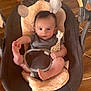 baby, infant, baby_swing, giraffe_toy, plush, wooden_floor, child, cute, indoors, seat, holding_foot, toy, soft, comfort, young_child, person, baby_clothing, play, relax, expression