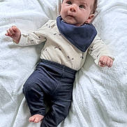 Declan joined the competition — help win amazing prizes! baby, infant, blanket, clothing, bib, pants, shirt, face, feet, hand, lying_down, cute, indoors, soft_texture, white_background, newborn, child, portrait, young, sleepwear