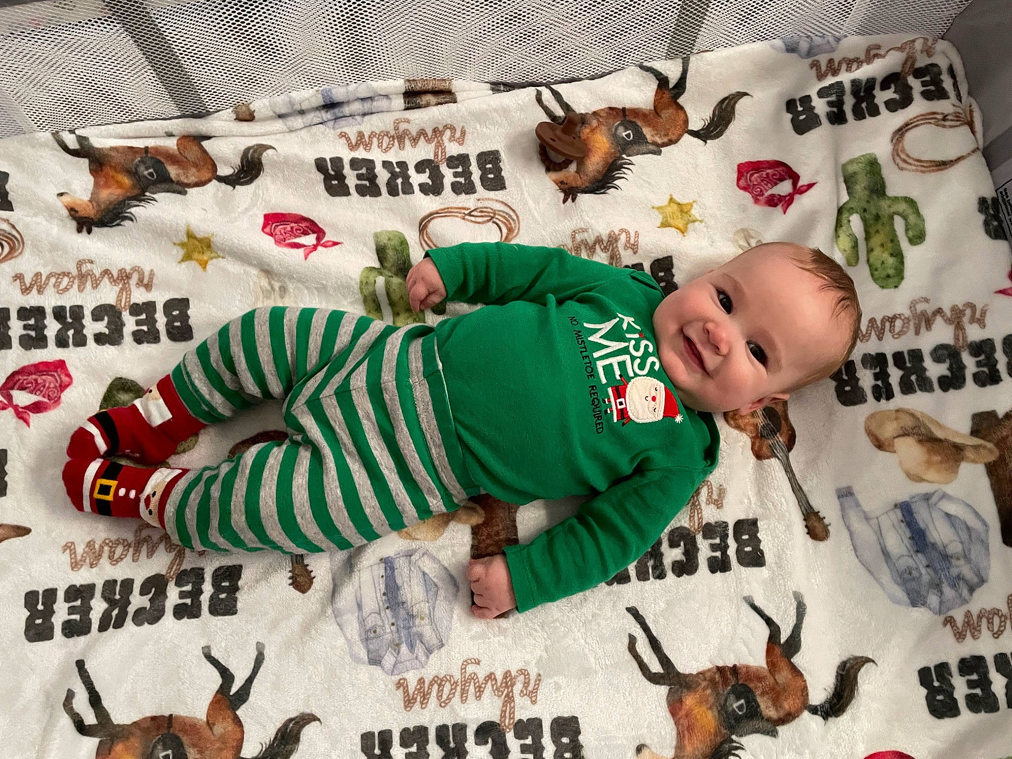 Becker is registered to the contest to win money with this photo: baby, baby_products, baby_toddler_clothing, child, design, event, fictional_character, font, happy, joy, linens, mammal, pattern, person, photo_caption, product, sleeve, smile, t_shirt, textile