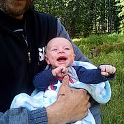 Theodore joined the competition — help win amazing prizes! baby, man, smiling, outdoor, forest, greenery, blanket, happy, holding, nature, casual_clothing, beard, light, daylight, portrait, closeup, child, adult, grass, trees