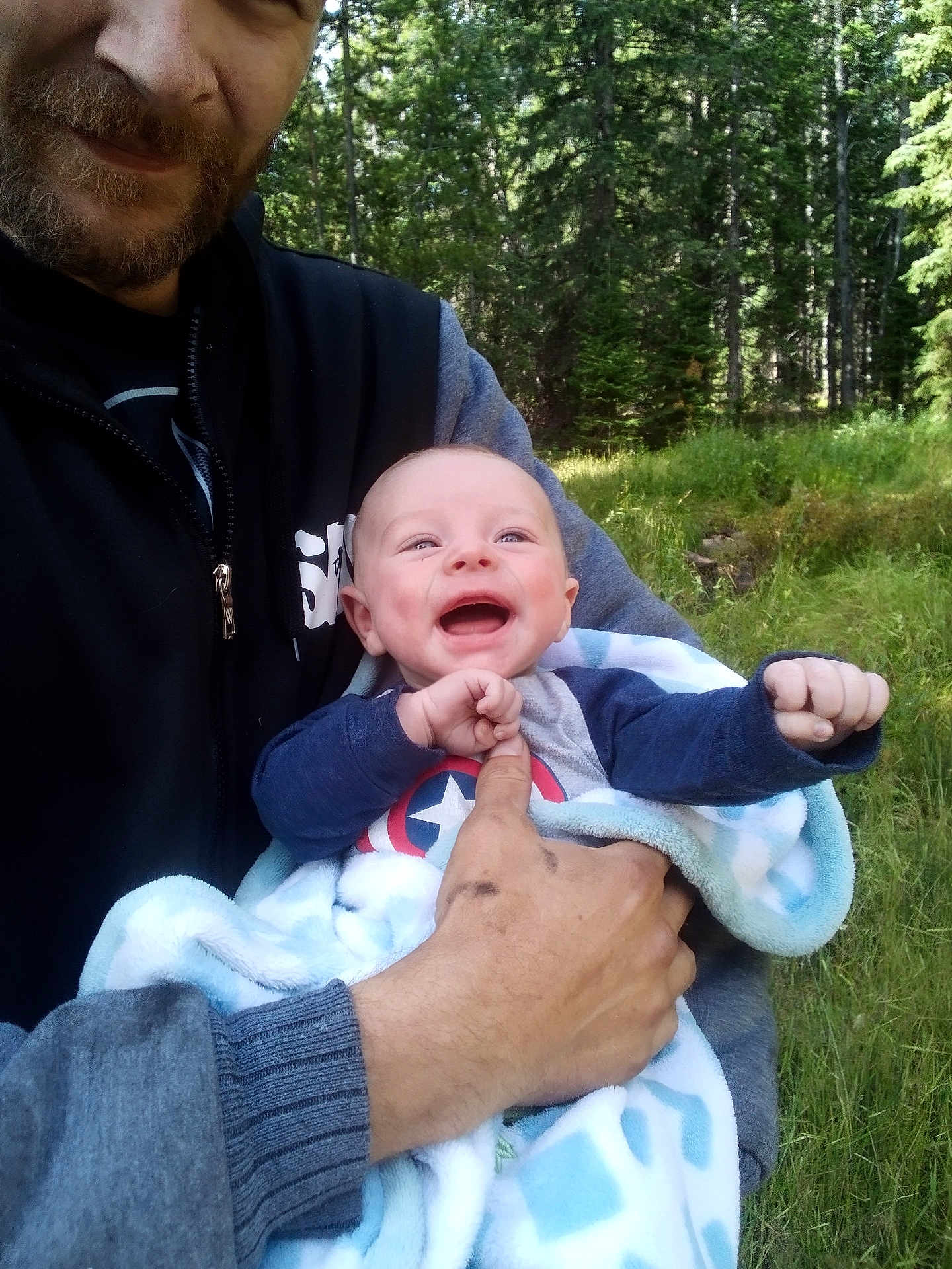 Theodore joined the competition — help win amazing prizes! baby, man, smiling, outdoor, forest, greenery, blanket, happy, holding, nature, casual_clothing, beard, light, daylight, portrait, closeup, child, adult, grass, trees