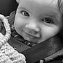 baby, child, smiling, black_and_white, close_up, face, eyes, blanket, car_seat, toy, beads, clothing, cute, infant, portrait, happy, seatbelt, texture, young, person