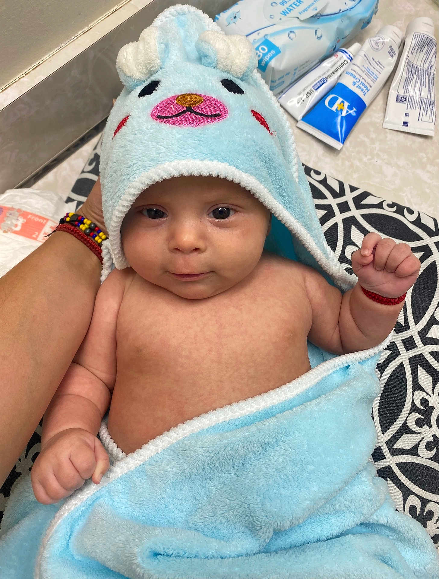 Daniel joined the competition — help win amazing prizes! baby, infant, child, towel, blue_towel, animal_hood, cute, face, hand, skin, bath_time, wipes, cream, patterned_surface, supporting_hand, expression, indoors, soft_texture, wrapped, blanket