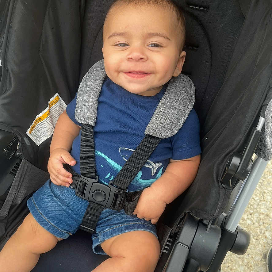Bryan joined the competition — help win amazing prizes! baby, baby_boy, baby_clothes, blue_shirt, blue_socks, casual, child, cute, denim_shorts, happy, harness, infant, outdoor, person, portrait, seat, seatbelt, smiling, stroller, young_child
