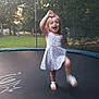 child, girl, trampoline, outdoor, grass, trees, dress, sandals, smiling, playing, motion_blur, nature, summer, happy, backyard, recreation, fun, person, jumping, daylight