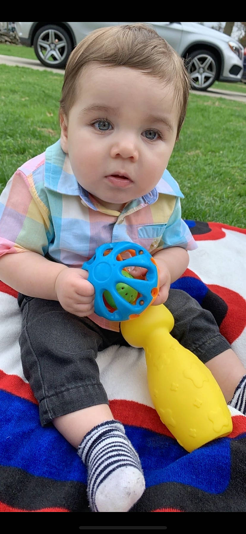 Joèl is registered to the contest to win money with this photo: baby_playing_with_toys, baby_toddler_clothing, blue, child, eye, face, finger, fun, grass, green, happy, head, leisure, person, photograph, plant, skin, summer, tire, toddler