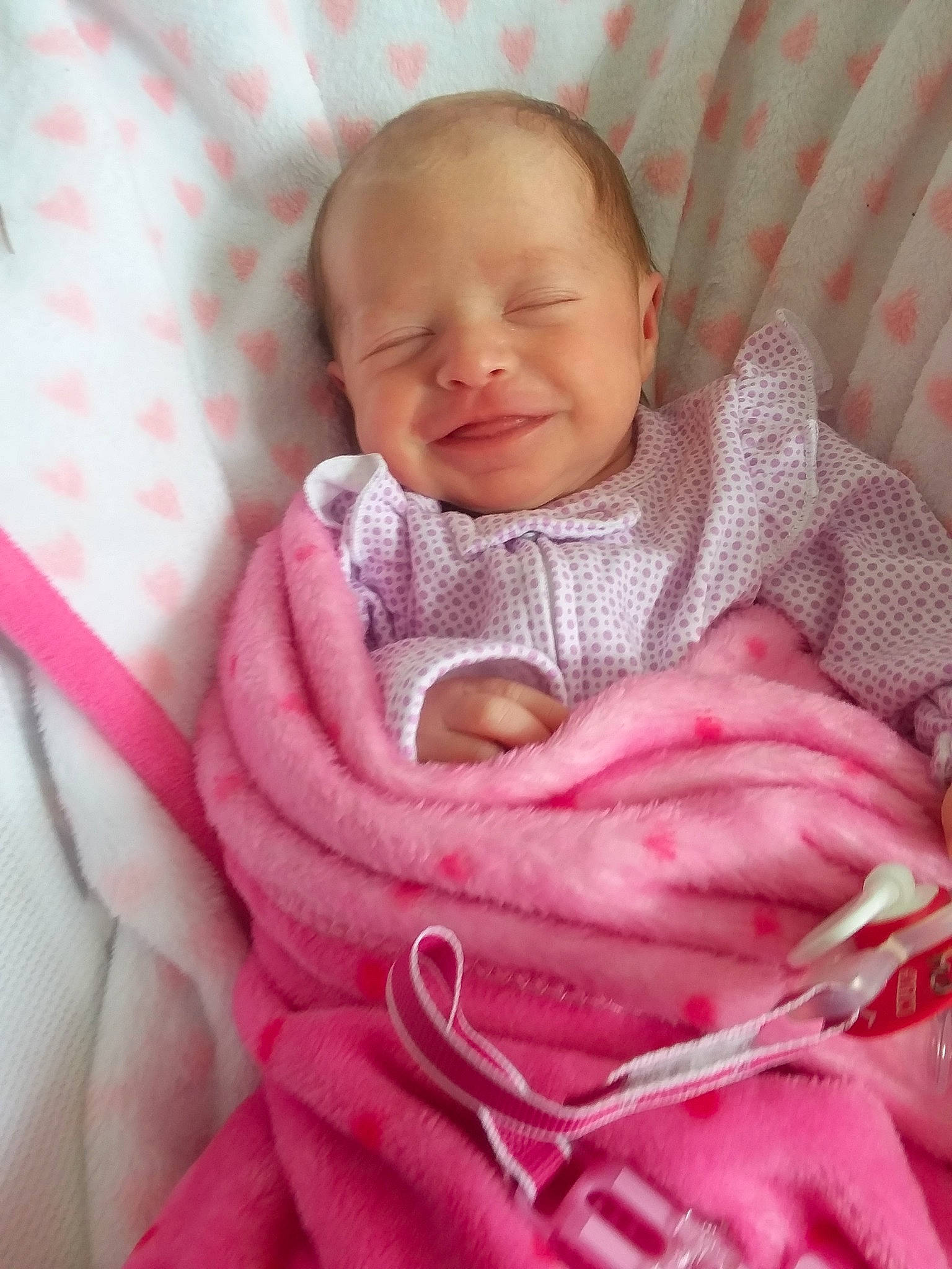 Charliee is registered to the contest to win money with this photo: baby, baby_products, bedding, bedtime, blanket, cheek, child, linens, magenta, mouth, person, pink, product, skin, smile, textile, toddler