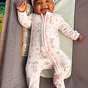 Keana joined the competition — help win amazing prizes! baby, infant, child, smiling, portrait, indoor, bouncer, baby_seat, pink_outfit, pajamas, headband, bow, minnie_mouse, cartoon_print, lying_down, raised_hand, happy, candid, nursery, soft_furnishings
