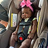 Keana joined the competition — help win amazing prizes! baby, infant, child, car_seat, vehicle, portrait, pink_bow, headband, safety_harness, seatbelt, car_interior, socks, floral_outfit, pacifier, fan, sitting, looking_at_camera, serious_expression, indoor, travel