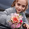 Nova is registered to the contest to win money with this photo: bouquet, car, car_window, child, close_up, coat, corsage, face, flower, girl, gray_coat, hand, makeup, nails, outdoor, portrait, rose, smile, tiara, young_girl
