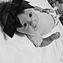 Gracie is registered to the contest to win money with this photo: adorable, baby, black_and_white, blanket, bow, child, clothing, cute, expression, eyes, face, hand, headwear, indoors, infant, lying_down, monochrome, newborn, portrait, soft_texture
