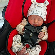 Gracie joined the competition — help win amazing prizes! baby, infant, car_seat, red_car_seat, sleeping, hat, pajamas, animal_print, foot, toes, straps, safety_buckle, child, indoors, cute, peaceful, newborn, resting, close_up, soft_lighting
