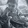 child, cat, couch, smile, black_and_white, indoor, cute, pet, girl, animal, cozy, affection, young, relaxing, casual_clothing, furniture, nap, comfort, home, tenderness