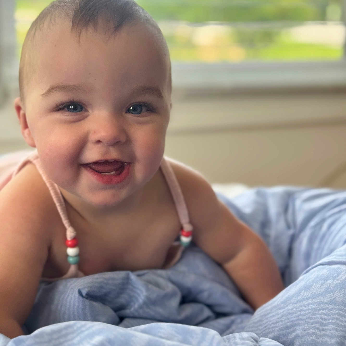 Evelynn joined the competition — help win amazing prizes! baby, bed, blanket, blue_eyes, child, closeup, clothing, comfort, cute, face, furniture, happy, indoors, infant, natural_light, person, portrait, skin, smiling, window