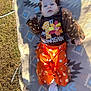 baby, child, infant, outdoor, blanket, grass, orange_clothing, brown_clothing, headband, bow, first_thanksgiving, socks, flower, patterned_blanket, celebration, festive, thanksgiving, cute, portrait, lying_down