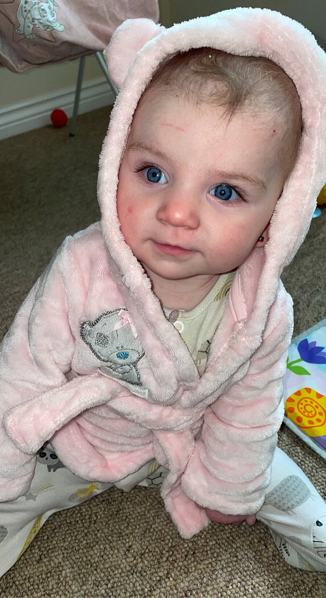 Jessica is registered to the contest to win money with this photo: baby, baby_toddler_clothing, blue, cheek, child, eyebrow, face, finger, gesture, happy, iris, lip, mouth, nose, person, pink, skin, sleeve, textile, toddler