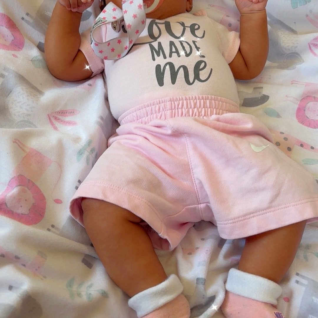 Nova joined the competition — help win amazing prizes! baby, infant, pacifier, pink_clothing, headband, bow, blanket, pattern, animal_print, lying_down, cute, child, soft_toys_pattern, socks, comfortable, indoors, sleepy, adorable, young_child, pastel_colors