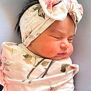 Mariam is registered to the contest to win money with this photo: baby, sleeping, headband, bow, blanket, floral, infant, newborn, peaceful, wrapped, soft, pink, cozy, cute, face, person, indoors, resting, child, portrait