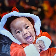 Journee joined the competition — help win amazing prizes! baby, celebration, child, christmas, cute, face, festive, fur_trim, happy, holiday, hood, indoors, infant, joy, portrait, red_clothing, santa_outfit, seasonal, smiling, warm