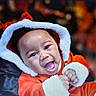 baby, child, smiling, happy, festive, holiday, christmas, santa_outfit, hood, fur_trim, red_clothing, portrait, cute, indoors, celebration, joy, face, infant, seasonal, warm