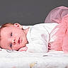 baby, infant, tutu, pink, white_onesie, blanket, soft_texture, lying_down, portrait, face, cute, newborn, child, blue_eyes, head, small_hands, resting, studio, soft_lighting, gray_background