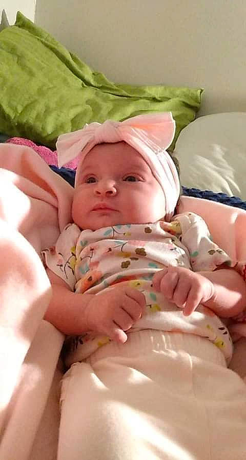 Adriana is registered to the contest to win money with this photo: abdomen, baby, baby_sleeping, baby_toddler_clothing, cheek, chest, child, comfort, head, headwear, leg, linens, nail, person, pink, product, skin, stomach, thigh, thumb