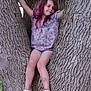 Zaylia is registered to the contest to win money with this photo: child, girl, tree, tree_trunk, purple_hair, floral_shirt, shorts, sneakers, outdoor, nature, playful, adventure, smiling, young, person, arms_outstretched, park, daylight, casual_clothing, relaxed