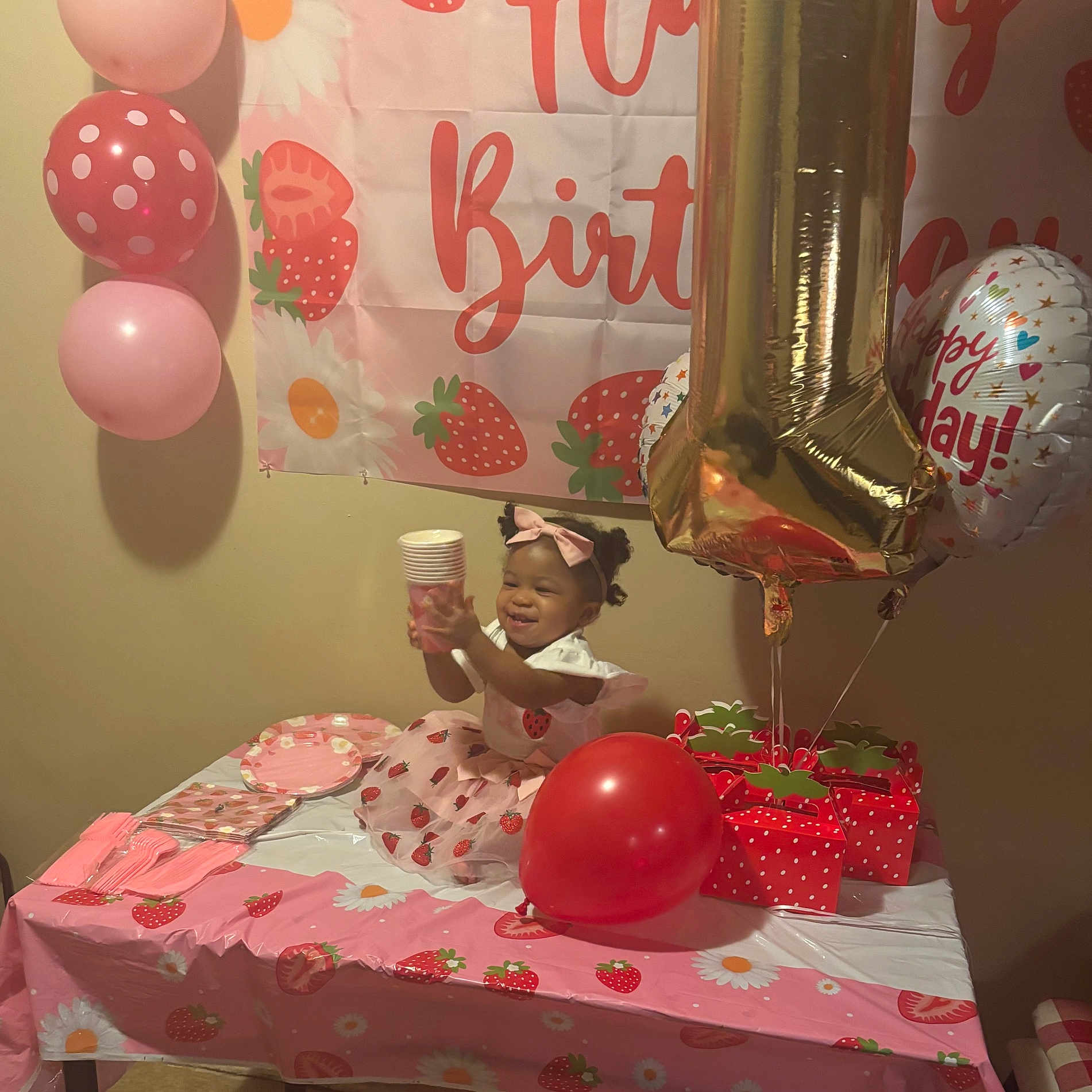 Shania joined the competition — help win amazing prizes! toddler, child, birthday, party, balloons, table, gift_boxes, pink, red, dress, bow, strawberry, banner, cups, napkins, plates, celebration, happy, indoor, smiling
