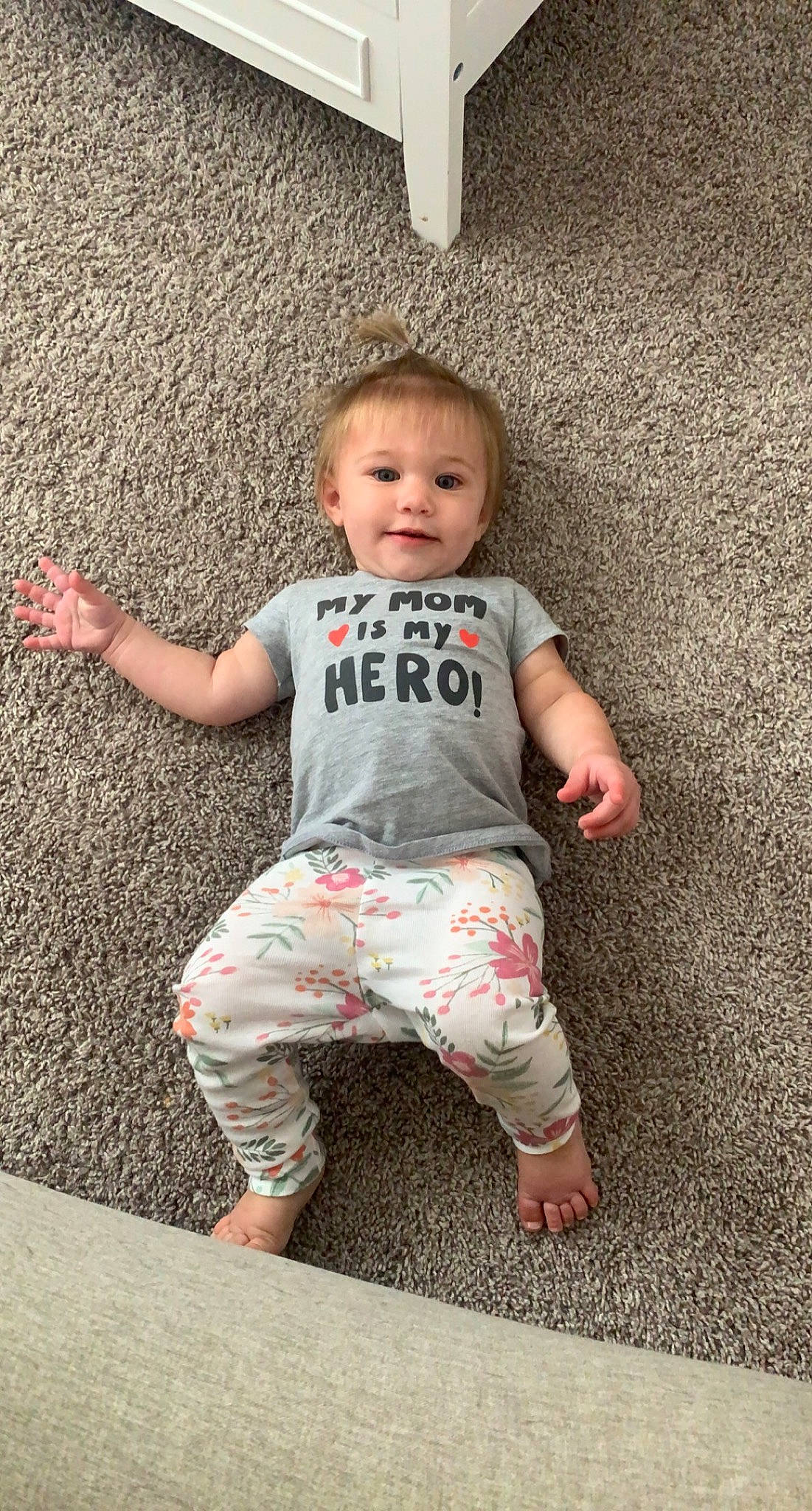 Savannah is registered to the contest to win money with this photo: baby, baby_toddler_clothing, cheek, eye, face, flash_photography, flooring, foot, fun, grass, happy, head, human_leg, leg, person, sitting, skin, sleeve, smile, t_shirt