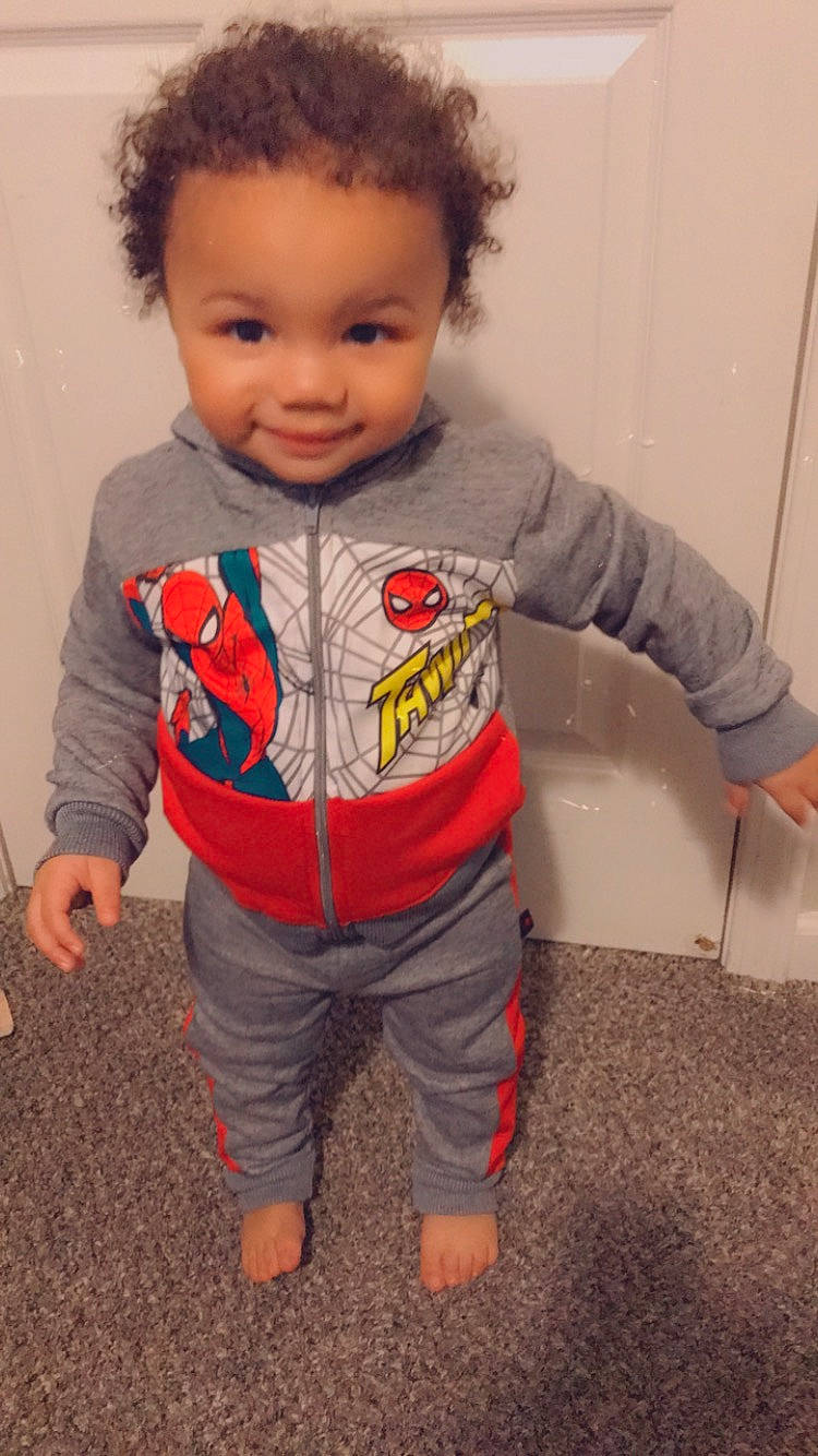 Jermaine is registered to the contest to win money with this photo: afro, baby, baby_products, baby_toddler_clothing, button, cheek, child, cool, fictional_character, forehead, jheri_curl, joint, joy, long_sleeved_t_shirt, nightwear, overall, person, pocket, sleeve, standing