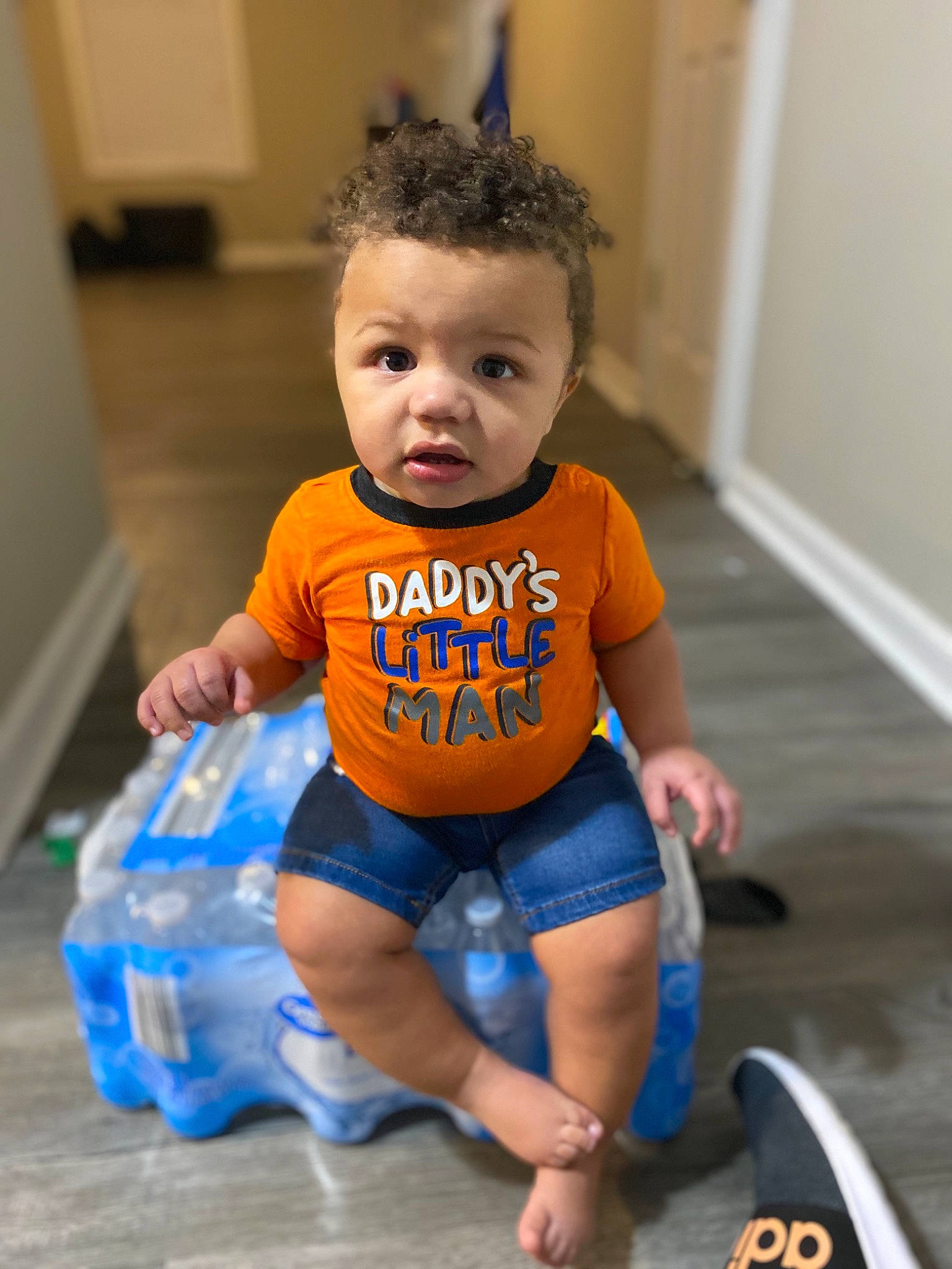 Jermaine is registered to the contest to win money with this photo: baby, baby_products, baby_toddler_clothing, blue, cheek, child, floor, flooring, joint, person, play, product, shoulder, sitting, standing, t_shirt, toddler, yellow