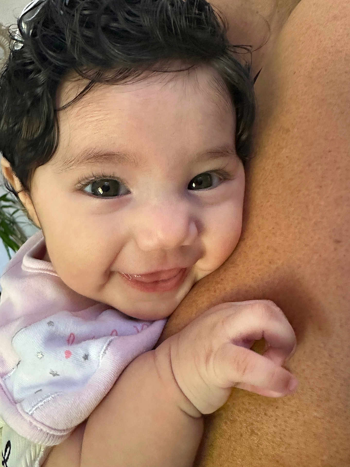 Layla is registered to the contest to win money with this photo: baby, infant, smile, face, hand, skin, closeup, expression, cute, child, person, human, warmth, snuggle, pink_clothing, curly_hair, happy, portrait, cuddling, soft