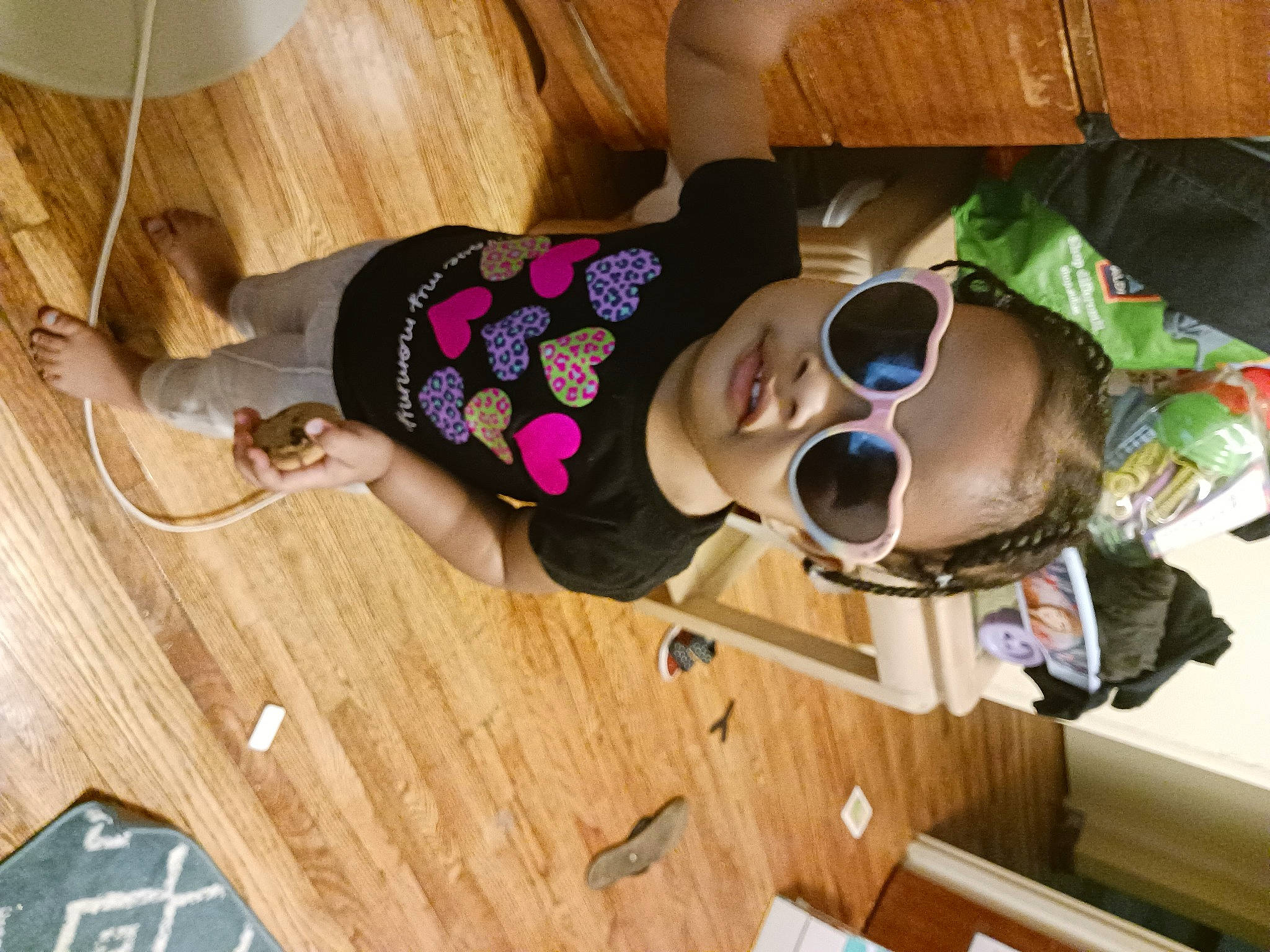 Clementine is registered to the contest to win money with this photo: baby_toddler_clothing, child, comfort, design, eyewear, floor, flooring, fun, goggles, hardwood, laminate_flooring, mammal, person, plank, room, smile, sunglasses, toddler, varnish, wood