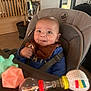 Sacha participe au concours pour gagner de l'argent avec cette photo : baby, high_chair, toy, smile, indoor, child, face, person, seatbelt, table, playtime, colorful, cheeky, curious, clothing, bib, head, happy, furniture, home