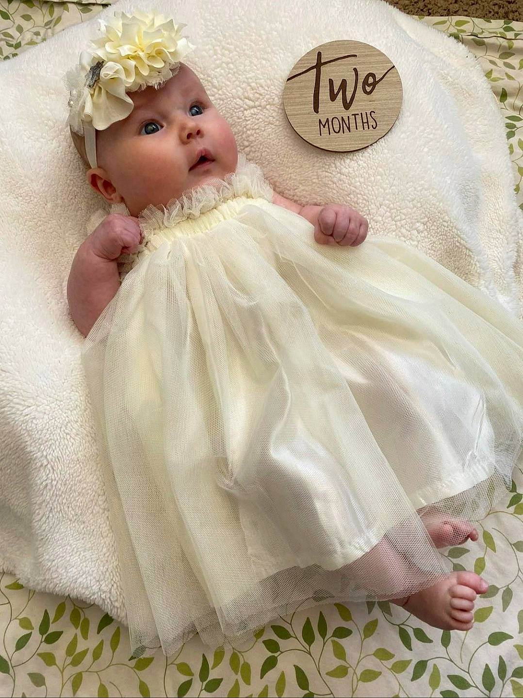 Novalee joined the competition — help win amazing prizes! baby, baby_toddler_clothing, bridal_accessory, bridal_clothing, dress, embellishment, eye, face, gown, happy, head, headgear, headpiece, headwear, person, petal, pink, plant, skin, textile