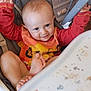 Evan a rejoint le concours — aidez-le/la à gagner de superbes lots ! baby, high_chair, smile, child, messy, food_stains, arms_raised, foot, shirt, indoor, furniture, drawer, playful, cute, infant, person, expression, seat, wooden_floor, cabinet
