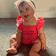Ivy-Rae is registered to the contest to win money with this photo: baby, child, smiling, sitting, headband, bow, pink_outfit, carpet, indoor, happy, cute, infant, chubby_arms, chubby_legs, portrait, expression, skin, floor, room, playful