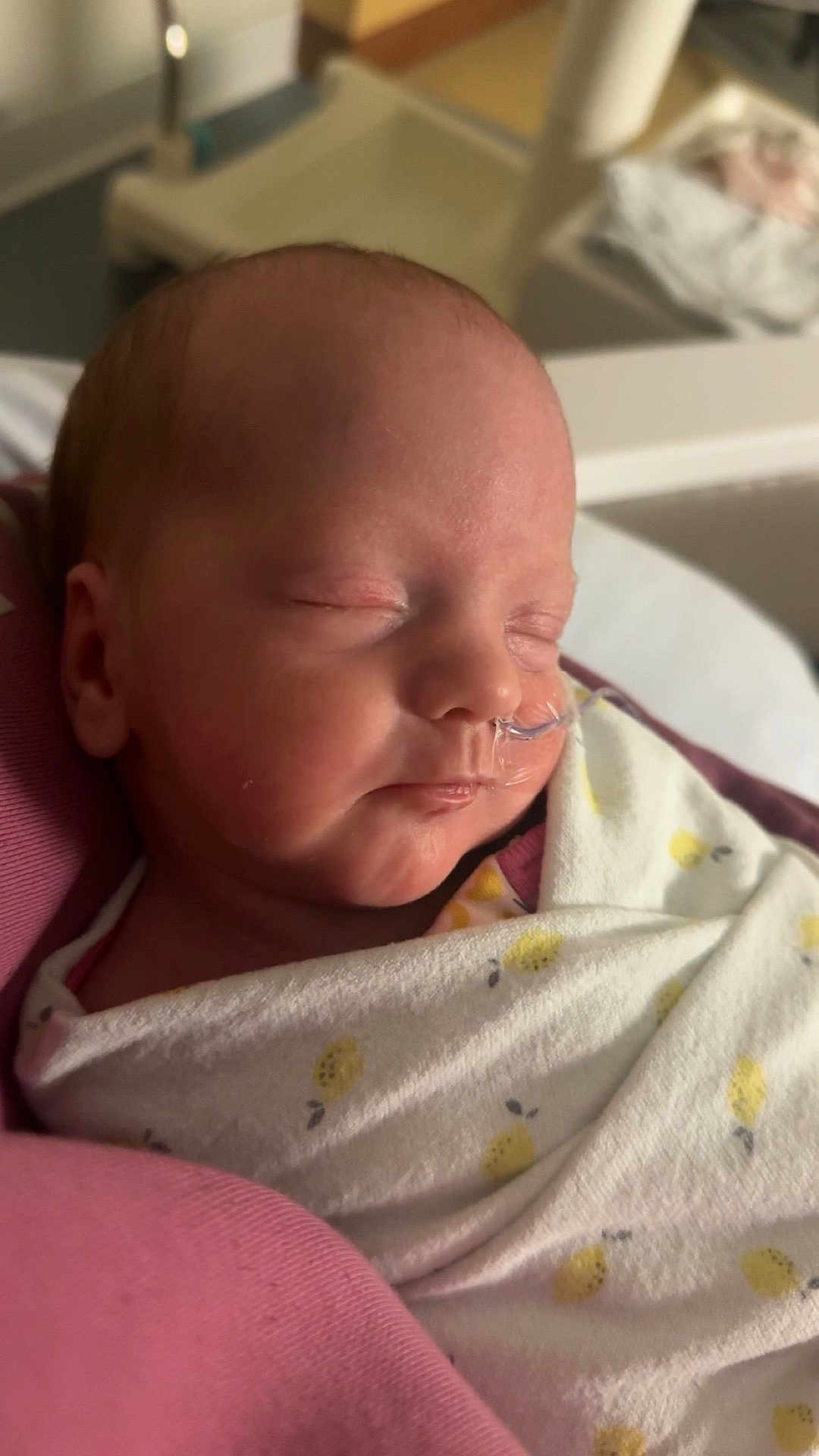 Avyn is registered to the contest to win money with this photo: baby, newborn, infant, sleeping, swaddle, blanket, feeding_tube, hospital, bassinet, portrait, closeup, peaceful, cheek, nose, mouth, head, pink, white, nursery, medical_tape