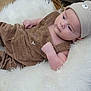 Andréas participe au concours pour gagner de l'argent avec cette photo : baby, infant, child, brown_overalls, bear_hat, fluffy_cushion, wicker_basket, indoor, relaxed, cute, soft_texture, person, clothing, headwear, portrait, skin, hand, face, comfort, resting