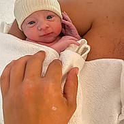 Isaac a rejoint le concours — aidez-le/la à gagner de superbes lots ! baby, newborn, infant, hat, towel, hand, arm, skin, parent, holding, portrait, closeup, hospital, blanket, swaddled, eyes_open, cute, tiny, facial_expression, newborn_hat