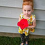 Adalynn joined the competition — help win amazing prizes! child, girl, red_hair, hibiscus, flower, sunflower_dress, polka_dot_leggings, flip_flops, grass, outdoor, portrait, blue_eyes, curly_hair, hair_bun, siding_wall, smile, standing, holding_flower, playful, cute