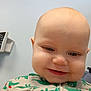 Wyatt is registered to the contest to win money with this photo: child, baby, infant, portrait, close_up, smile, bald_head, chubby_cheeks, onesie, patterned_clothing, eyes, nose, mouth, face, indoor, clinic, medical_device, wall, cute, happy