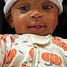 baby, child, infant, smiling, hat, knit_hat, onesie, pumpkins, orange, white, face, cute, portrait, sleepwear, cozy, lying_down, young_child, apparel, pattern, comfort