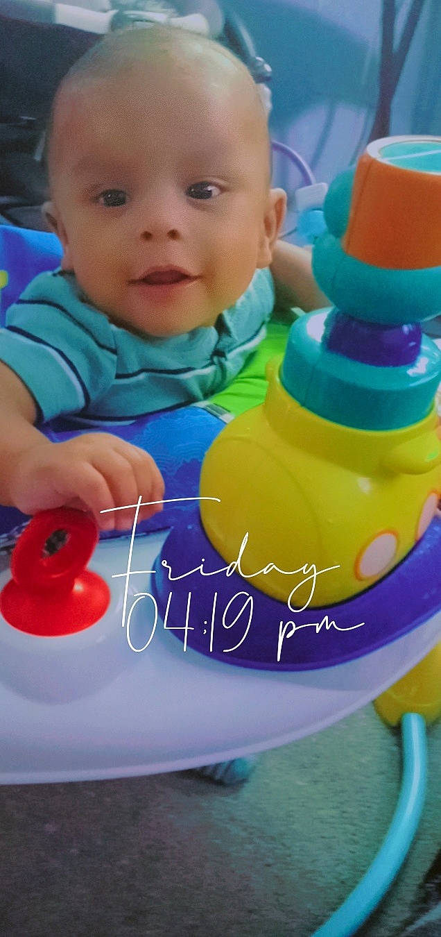 Jesùs is registered to the contest to win money with this photo: aqua, baby, baby_playing_with_toys, baby_products, baby_toddler_clothing, child, drinkware, electric_blue, facial_expression, fun, happy, leisure, organ, person, product, skin, sleeve, smile, toddler, toy
