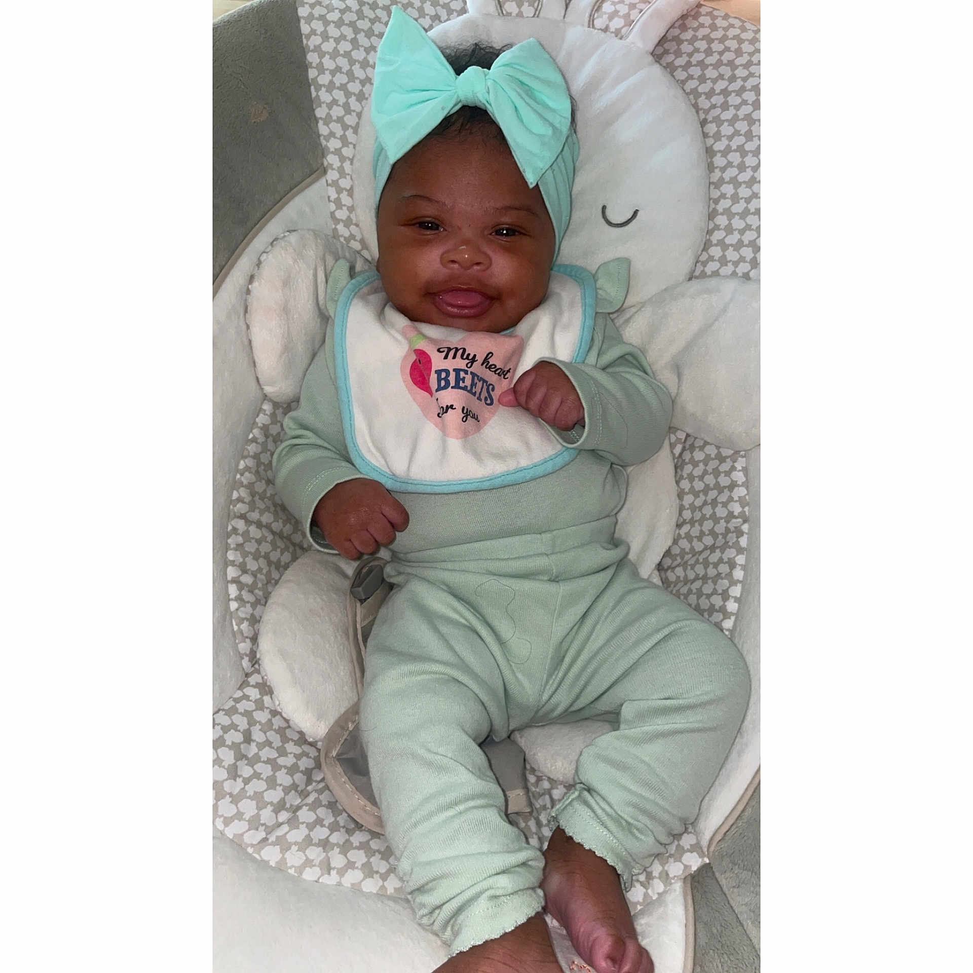 Ivy joined the competition — help win amazing prizes! baby, babylaughing, bonnet, clothing, coat, cushion, face, furniture, happy, hat, head, homedecor, hood, jacket, newborn, person, photography, portrait, sitting, smile