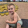 Jaxson joined the competition — help win amazing prizes! toddler, child, smiling, shirtless, outdoor, concrete, plaque, rotary_international, emblem, grass, trees, parked_cars, shorts, black_shoes, happy, blue_eyes, blond_hair, sitting, daylight, nature