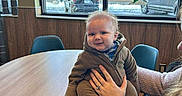 Walker joined the competition — help win amazing prizes! baby, child, person, table, chair, window, indoor, cozy, winter, holiday, decoration, snowman, candle, smile, clothing, hand, support, wood, furniture, casual