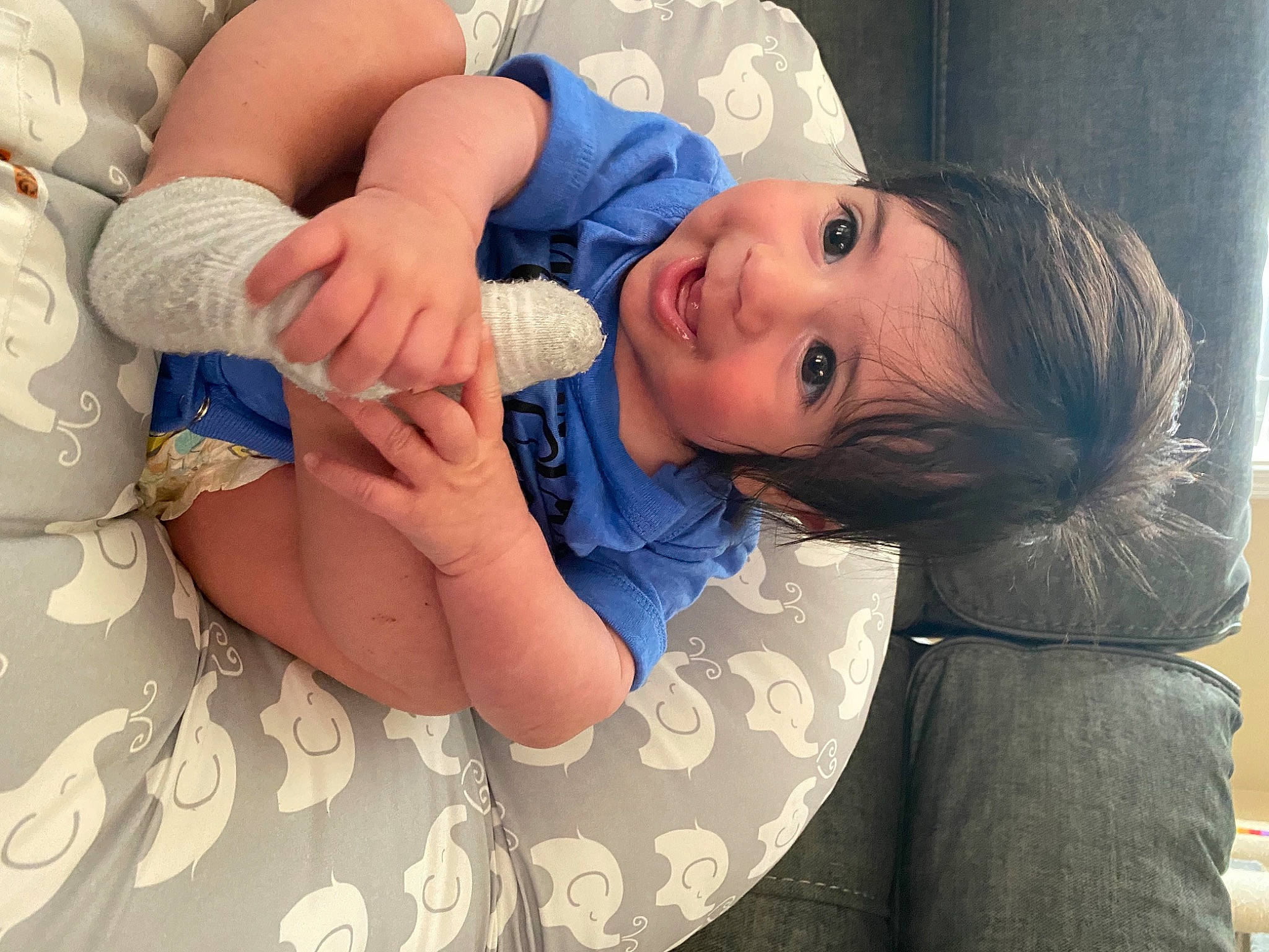 Gerardo is registered to the contest to win money with this photo: arm, baby, baby_toddler_clothing, cheek, comfort, eye, eyelash, face, finger, gesture, hand, happy, head, human_body, lip, mouth, nail, person, skin, thumb