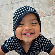 Jassiel joined the competition — help win amazing prizes! toddler, child, smile, hoodie, striped_clothing, happy, face, teeth, floor, tile, barefoot, looking_up, person, casual_clothing, cute, indoors, young_child, joyful, portrait, playful